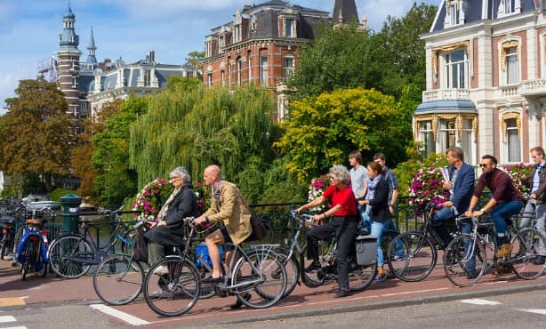 Full bike lanes and cyclists using smartphones in Dutch cities