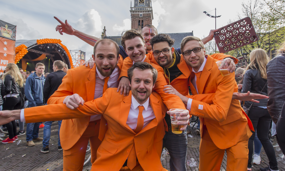 Dutch people wearing orange celebrating King's Day in Alkmaar